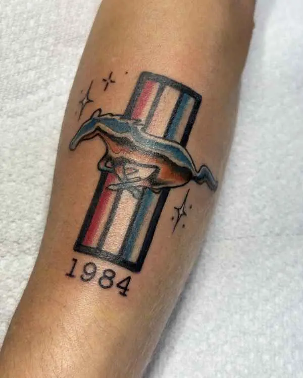 A color Mustang pony emblem over red, white and blue bars with stars and the year 1984, by Shannon Moxie