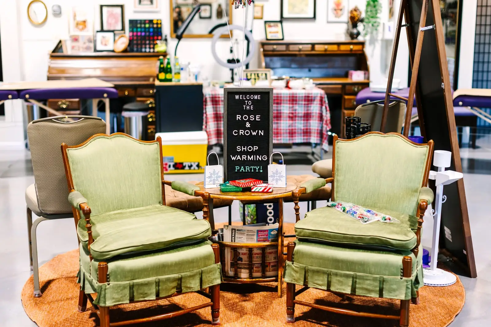 Sage armchairs and a shop-warming letter board in the Rose and Crown lounge