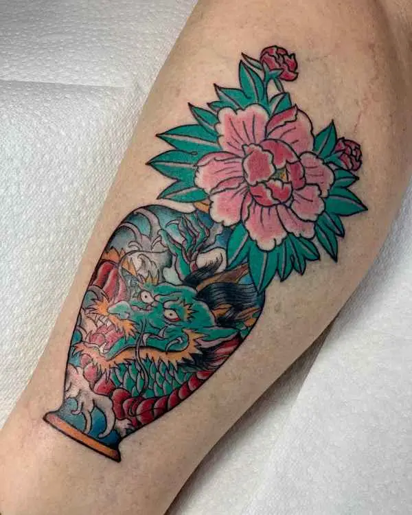 A traditional color tattoo of a dragon vase holding a pink peony, by Shannon Moxie